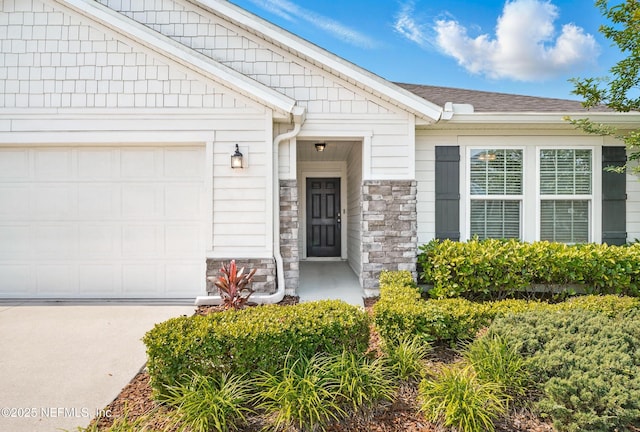 12372 Golden Bell Dr, Jacksonville, FL 32225 - property entrance featuring a garage, stone siding, driveway, and a shingled roof