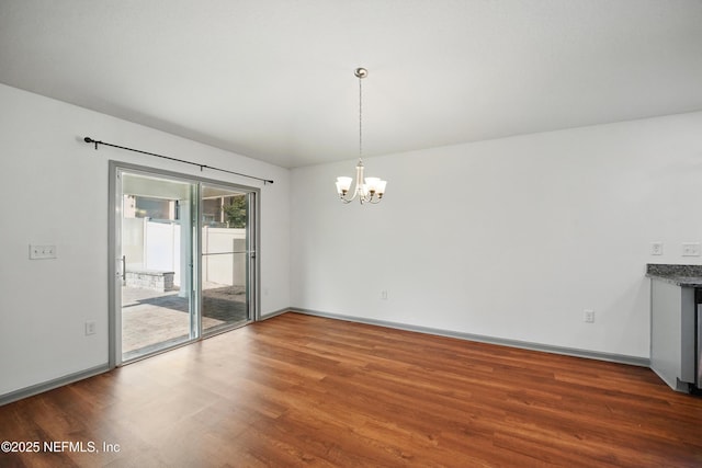 12372 Golden Bell Dr, Jacksonville, FL 32225 - unfurnished dining area with a chandelier, wood finished floors, and baseboards