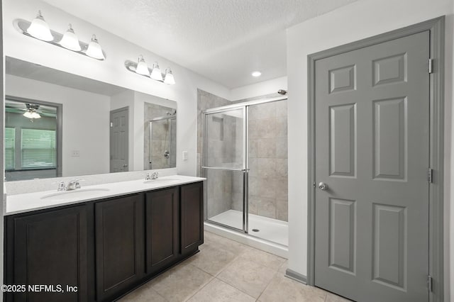 12372 Golden Bell Dr, Jacksonville, FL 32225 - full bath with a stall shower, tile patterned flooring, ceiling fan, double vanity, and a textured ceiling