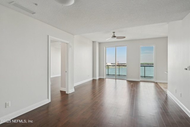 1431 Riverplace Blvd Unit 1707, Jacksonville, FL 32207 - unfurnished room featuring ceiling fan, dark wood finished floors, baseboards, and a textured ceiling