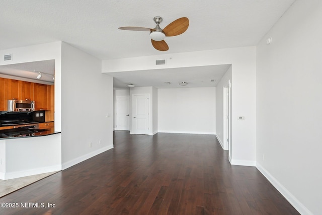 1431 Riverplace Blvd Unit 1707, Jacksonville, FL 32207 - unfurnished living room featuring dark wood-type flooring, ceiling fan, and baseboards