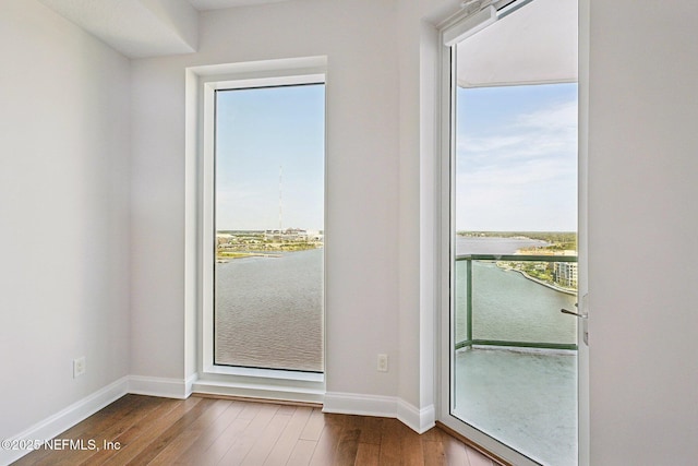 1431 Riverplace Blvd Unit 1707, Jacksonville, FL 32207 - doorway with dark wood finished floors, baseboards, and a water view
