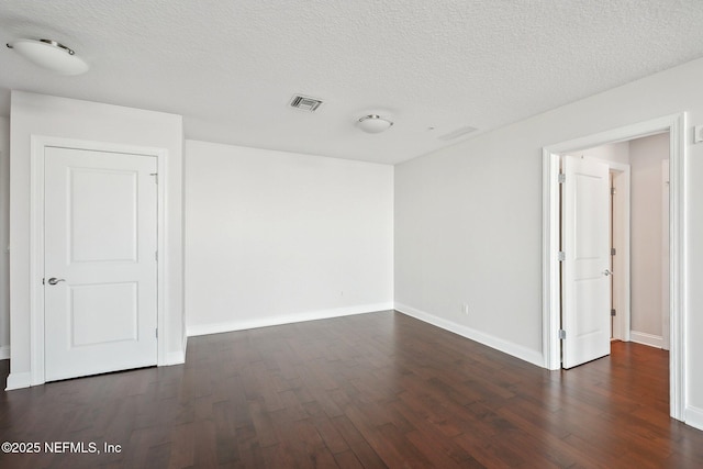1431 Riverplace Blvd Unit 1707, Jacksonville, FL 32207 - spare room with dark wood-type flooring, baseboards, and a textured ceiling