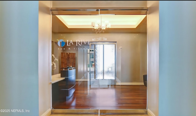 1431 Riverplace Blvd Unit 1707, Jacksonville, FL 32207 - foyer entrance with baseboards, a chandelier, wood finished floors, and a raised ceiling