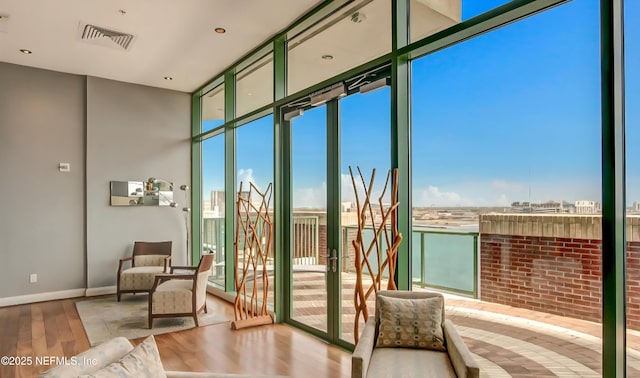 1431 Riverplace Blvd Unit 1707, Jacksonville, FL 32207 - doorway with wood finished floors, expansive windows, and baseboards