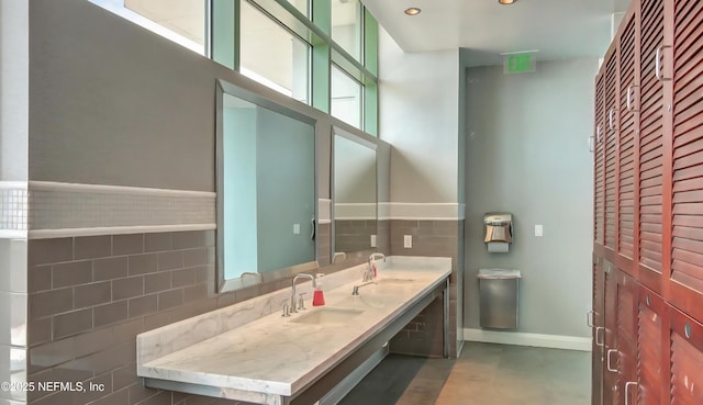 1431 Riverplace Blvd Unit 1707, Jacksonville, FL 32207 - bathroom with double vanity, tile walls, and recessed lighting