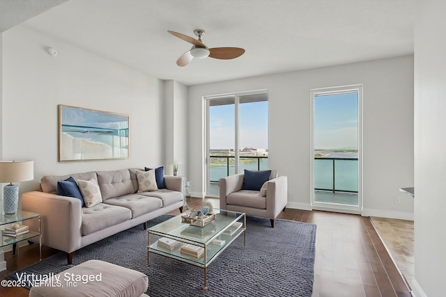 1431 Riverplace Blvd Unit 1707, Jacksonville, FL 32207 - living room with a ceiling fan, wood finished floors, a water view, and baseboards