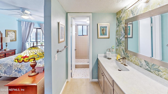 21 Mid Pines Cir, Palm Coast, FL 32137 - bathroom with vanity, ceiling fan, a stall shower, a textured ceiling, and baseboards