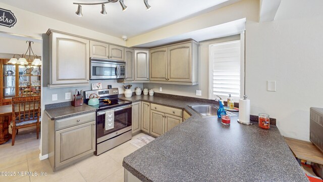21 Mid Pines Cir, Palm Coast, FL 32137 - kitchen with stainless steel appliances, dark countertops, a sink, and light tile patterned floors