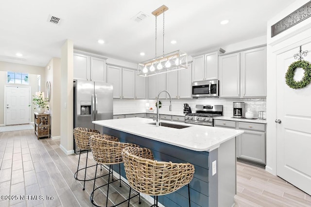 488 Montserrat Dr, Saint Augustine, FL 32092 - kitchen with stainless steel appliances, a sink, a kitchen bar, decorative backsplash, and recessed lighting