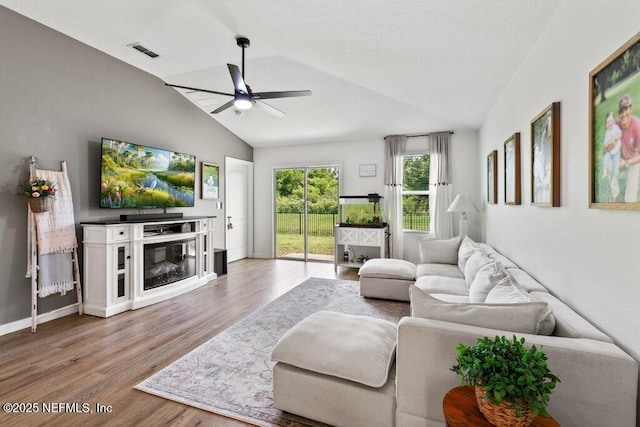 12097 Grand Herring Way, Jacksonville, FL 32219 - living room with vaulted ceiling, a ceiling fan, wood finished floors, and baseboards