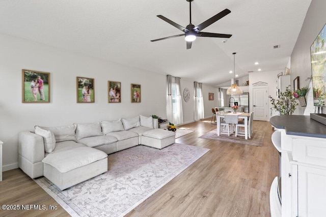 12097 Grand Herring Way, Jacksonville, FL 32219 - living room featuring lofted ceiling, a ceiling fan, light wood finished floors, recessed lighting, and baseboards