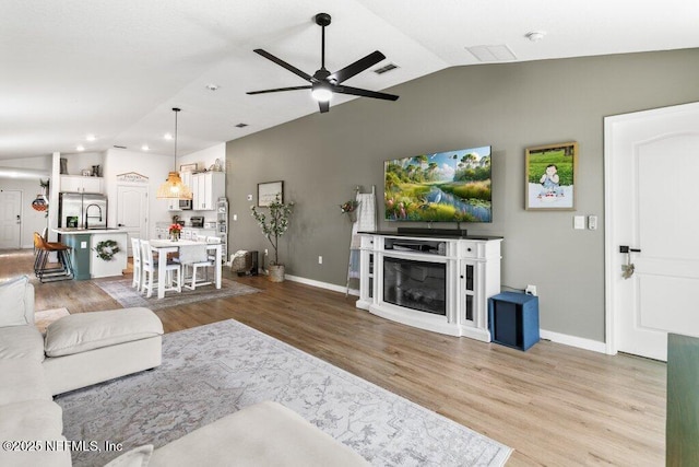 12097 Grand Herring Way, Jacksonville, FL 32219 - living room with lofted ceiling, ceiling fan, baseboards, wood finished floors, and recessed lighting