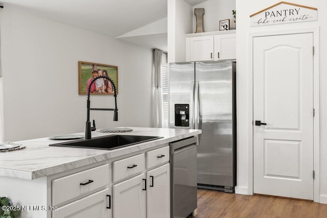 12097 Grand Herring Way, Jacksonville, FL 32219 - kitchen featuring appliances with stainless steel finishes, a sink, a center island with sink, light countertops, and white cabinets