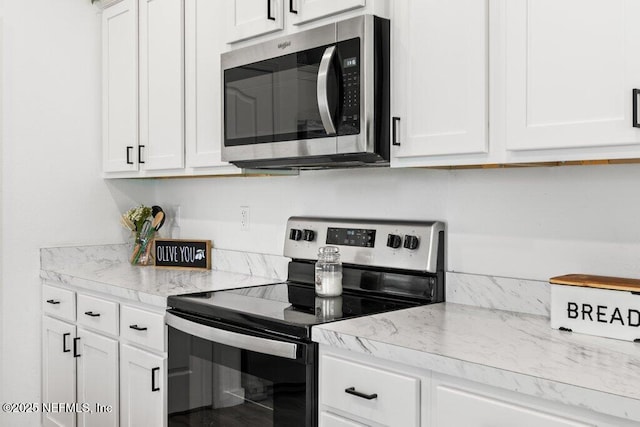 12097 Grand Herring Way, Jacksonville, FL 32219 - kitchen with appliances with stainless steel finishes, white cabinets, and light stone countertops