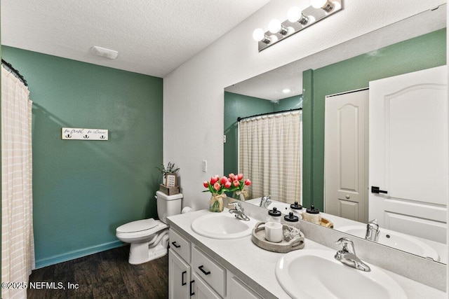 12097 Grand Herring Way, Jacksonville, FL 32219 - full bath with double vanity, wood finished floors, toilet, a textured ceiling, and curtained shower