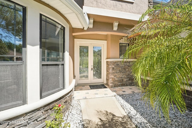 10065 Ecton Ln, Jacksonville, FL 32246 - doorway to property featuring french doors and stucco siding