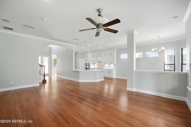 10065 Ecton Ln, Jacksonville, FL 32246 - unfurnished living room featuring ceiling fan, wood finished floors, ornamental molding, a chandelier, and baseboards
