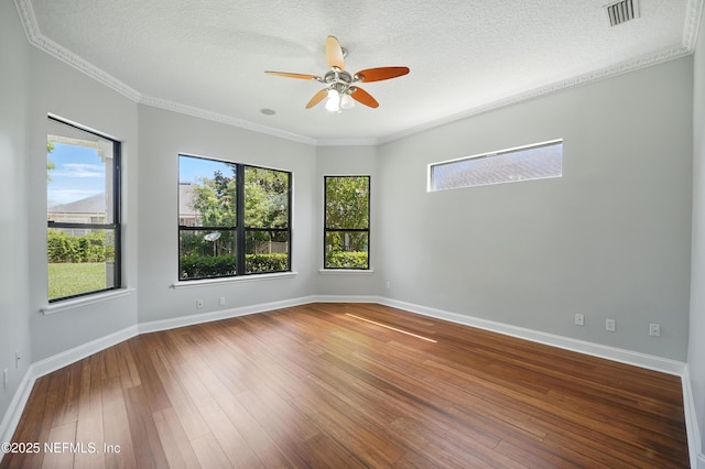 10065 Ecton Ln, Jacksonville, FL 32246 - unfurnished room with healthy amount of natural light, wood-type flooring, a ceiling fan, baseboards, and crown molding
