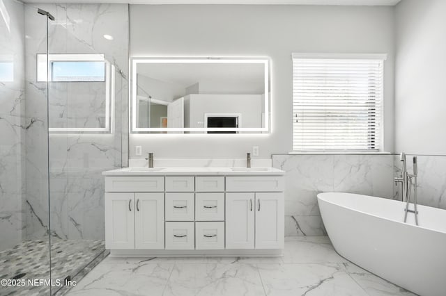 10065 Ecton Ln, Jacksonville, FL 32246 - full bath with a marble finish shower, marble finish flooring, a freestanding bath, double vanity, and a wainscoted wall