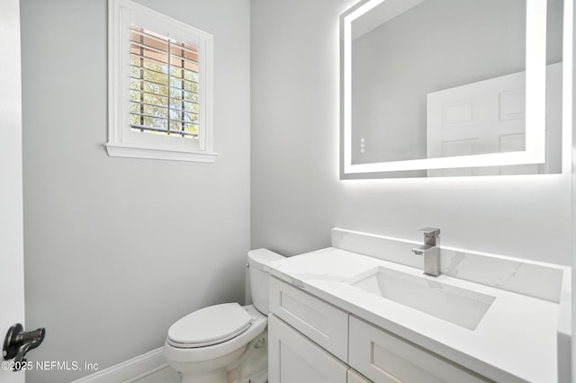 10065 Ecton Ln, Jacksonville, FL 32246 - bathroom featuring toilet, vanity, and baseboards