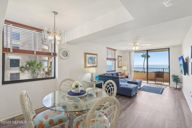 3360 Ocean Shore Blvd Unit 3070, Ormond Beach, FL 32176 - dining room with wood finished floors, a textured ceiling, ceiling fan, a chandelier, and baseboards