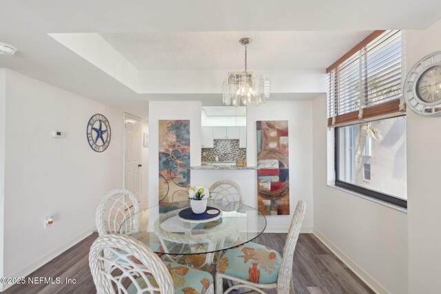 3360 Ocean Shore Blvd Unit 3070, Ormond Beach, FL 32176 - dining area featuring dark wood-style floors, a chandelier, and baseboards