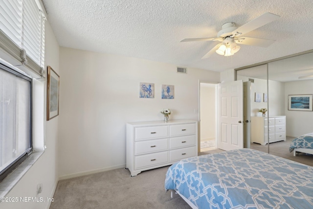 3360 Ocean Shore Blvd Unit 3070, Ormond Beach, FL 32176 - carpeted bedroom with a textured ceiling, a ceiling fan, a closet, and baseboards