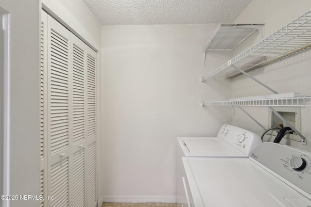 3360 Ocean Shore Blvd Unit 3070, Ormond Beach, FL 32176 - laundry room featuring washer and dryer, a textured ceiling, and baseboards