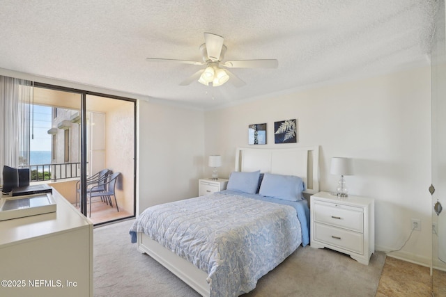 3360 Ocean Shore Blvd Unit 3070, Ormond Beach, FL 32176 - bedroom featuring a textured ceiling, access to exterior, a ceiling fan, and baseboards