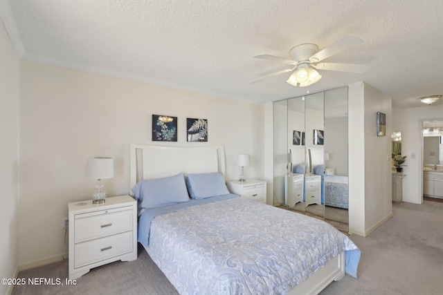 3360 Ocean Shore Blvd Unit 3070, Ormond Beach, FL 32176 - bedroom with light carpet, a closet, a textured ceiling, ceiling fan, and ensuite bathroom