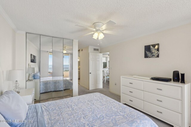 3360 Ocean Shore Blvd Unit 3070, Ormond Beach, FL 32176 - bedroom featuring a closet, a textured ceiling, and a ceiling fan