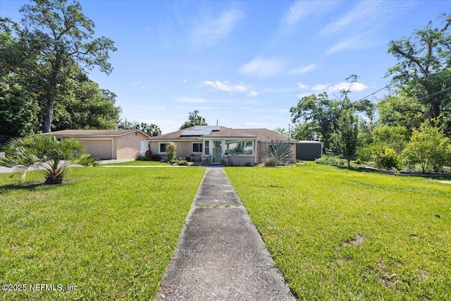8615 2nd Ave, Jacksonville, FL 32208 - view of front of property featuring solar panels and a front yard