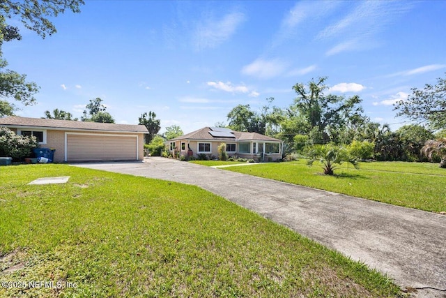 8615 2nd Ave, Jacksonville, FL 32208 - single story home featuring concrete driveway, solar panels, a front lawn, and a garage