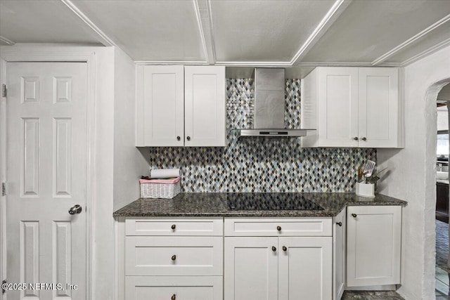 8615 2nd Ave, Jacksonville, FL 32208 - kitchen with wall chimney exhaust hood, black electric cooktop, white cabinetry, and arched walkways