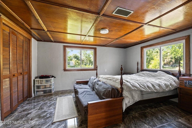 8615 2nd Ave, Jacksonville, FL 32208 - bedroom featuring multiple windows, wood ceiling, dark marble finish floors, and a closet