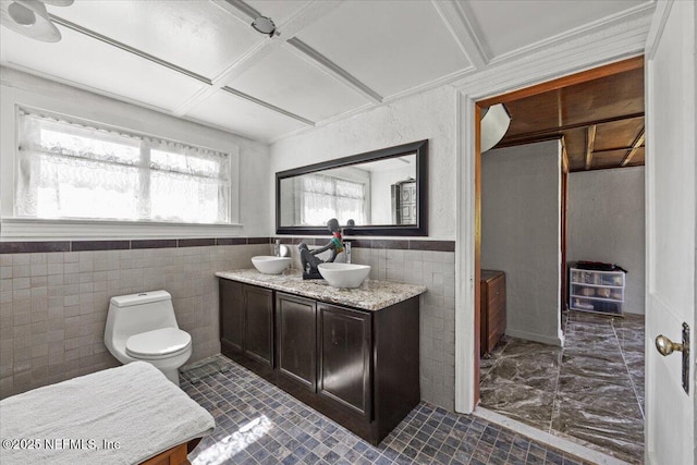 8615 2nd Ave, Jacksonville, FL 32208 - bathroom with tile walls, double vanity, toilet, a wainscoted wall, and coffered ceiling