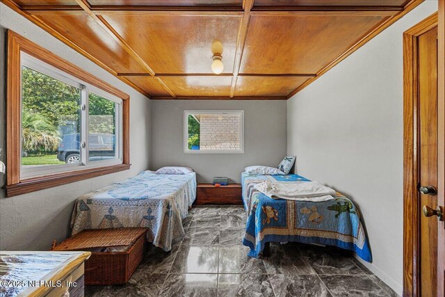 8615 2nd Ave, Jacksonville, FL 32208 - bedroom featuring baseboards, marble finish floors, crown molding, and wooden ceiling