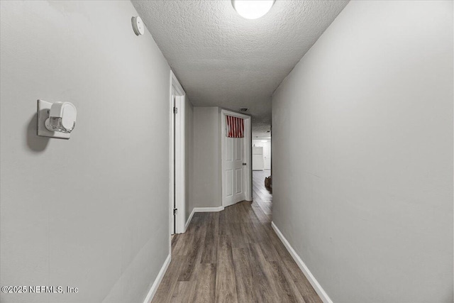 8615 2nd Ave, Jacksonville, FL 32208 - corridor featuring wood finished floors, a textured ceiling, and baseboards