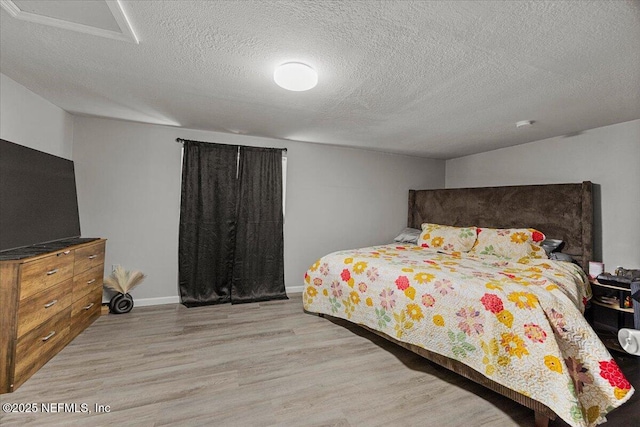 8615 2nd Ave, Jacksonville, FL 32208 - bedroom with wood finished floors, a textured ceiling, and baseboards