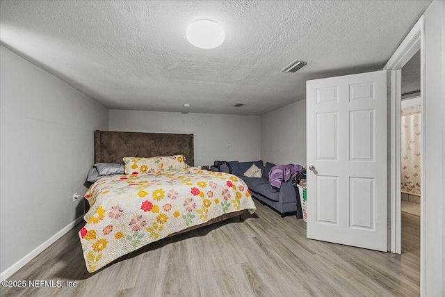 8615 2nd Ave, Jacksonville, FL 32208 - bedroom featuring wood finished floors, a textured ceiling, and baseboards