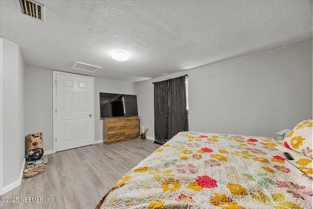 8615 2nd Ave, Jacksonville, FL 32208 - bedroom with wood finished floors, a textured ceiling, baseboards, and attic access