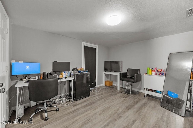 8615 2nd Ave, Jacksonville, FL 32208 - home office featuring wood finished floors and a textured ceiling