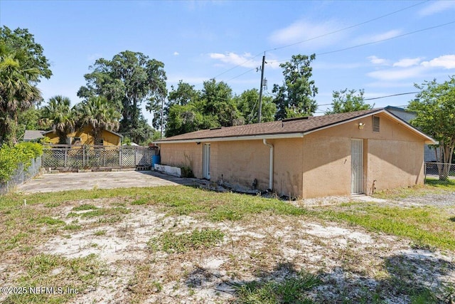 8615 2nd Ave, Jacksonville, FL 32208 - view of side of property featuring a patio area and stucco siding