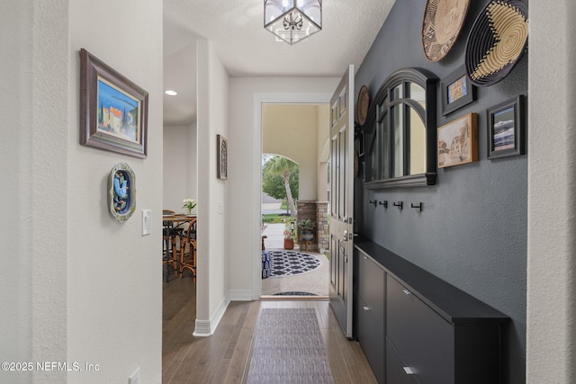 263 Forest Spring Dr, Ponte Vedra, FL 32081 - doorway with wood finished floors, a textured wall, and baseboards