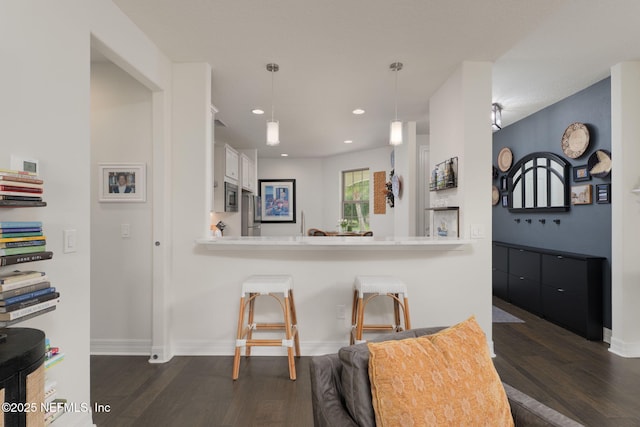 263 Forest Spring Dr, Ponte Vedra, FL 32081 - kitchen featuring dark wood-type flooring, white cabinets, decorative light fixtures, light countertops, and baseboards