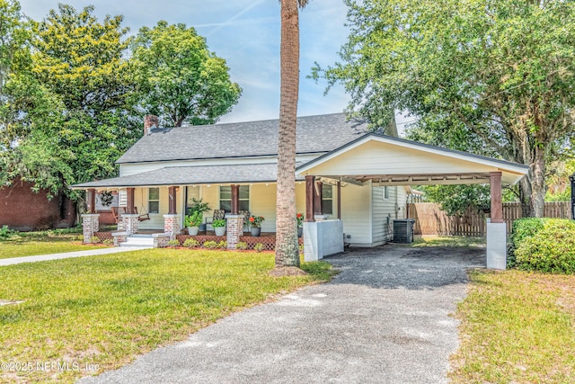 148 N 4th St, Macclenny, FL 32063 - view of front of home with covered porch, roof with shingles, driveway, a chimney, and central AC unit