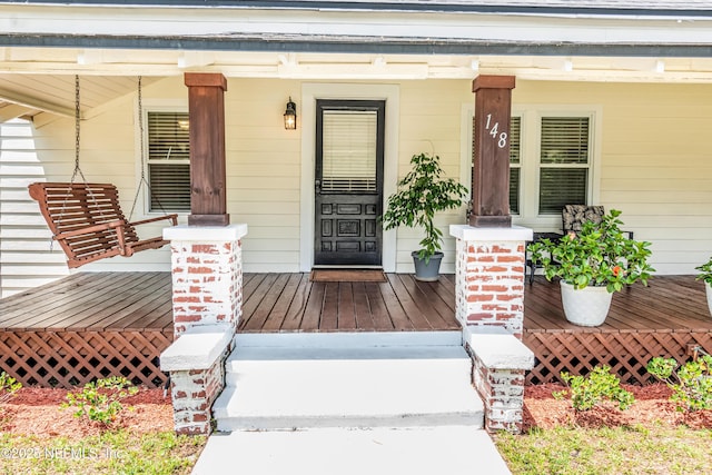 148 N 4th St, Macclenny, FL 32063 - view of exterior entry featuring covered porch