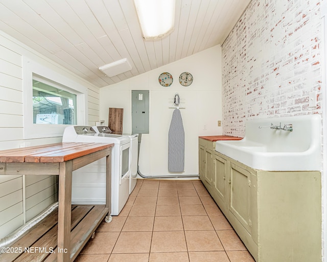 148 N 4th St, Macclenny, FL 32063 - kitchen with vaulted ceiling, a sink, washing machine and dryer, electric panel, and light tile patterned floors