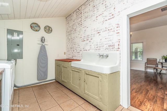 148 N 4th St, Macclenny, FL 32063 - bathroom featuring electric panel, wood ceiling, vaulted ceiling, washer / dryer, and a sink